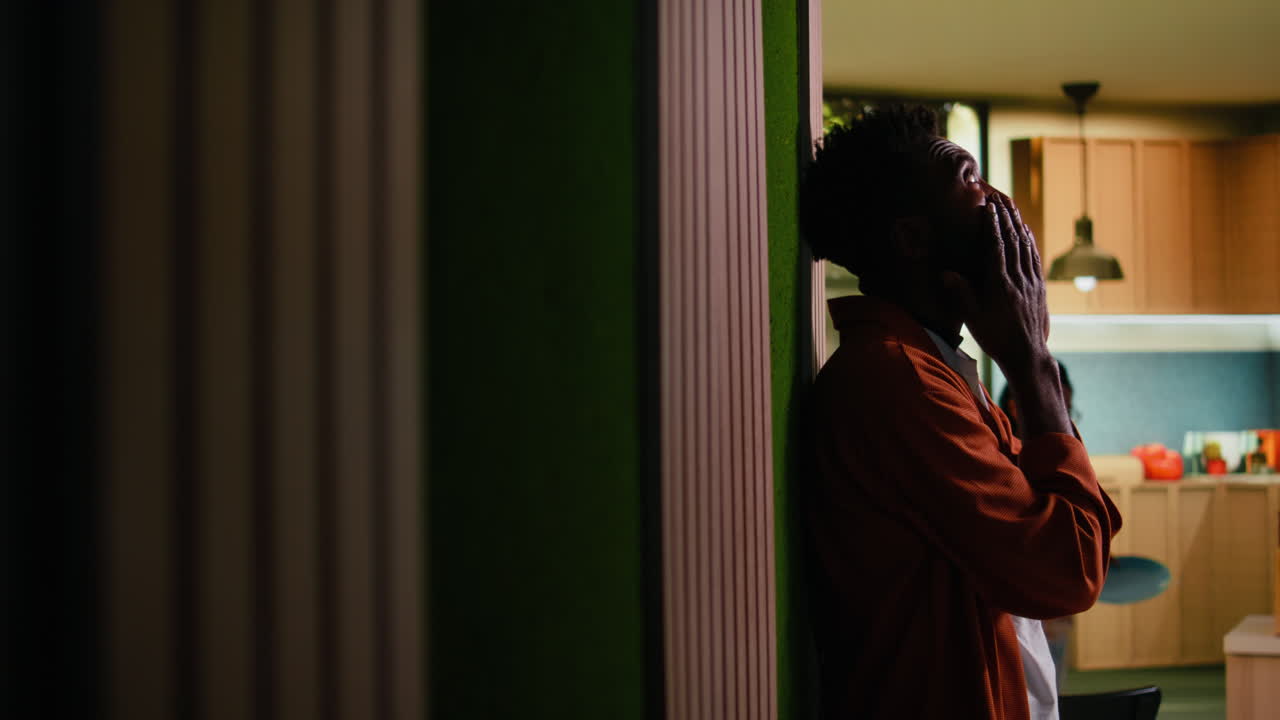 Distraught black man feels unfulfilled and disappointed in the hallway