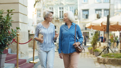 Two-Beautiful-Old-Women-Walking-The-City-And-Talking