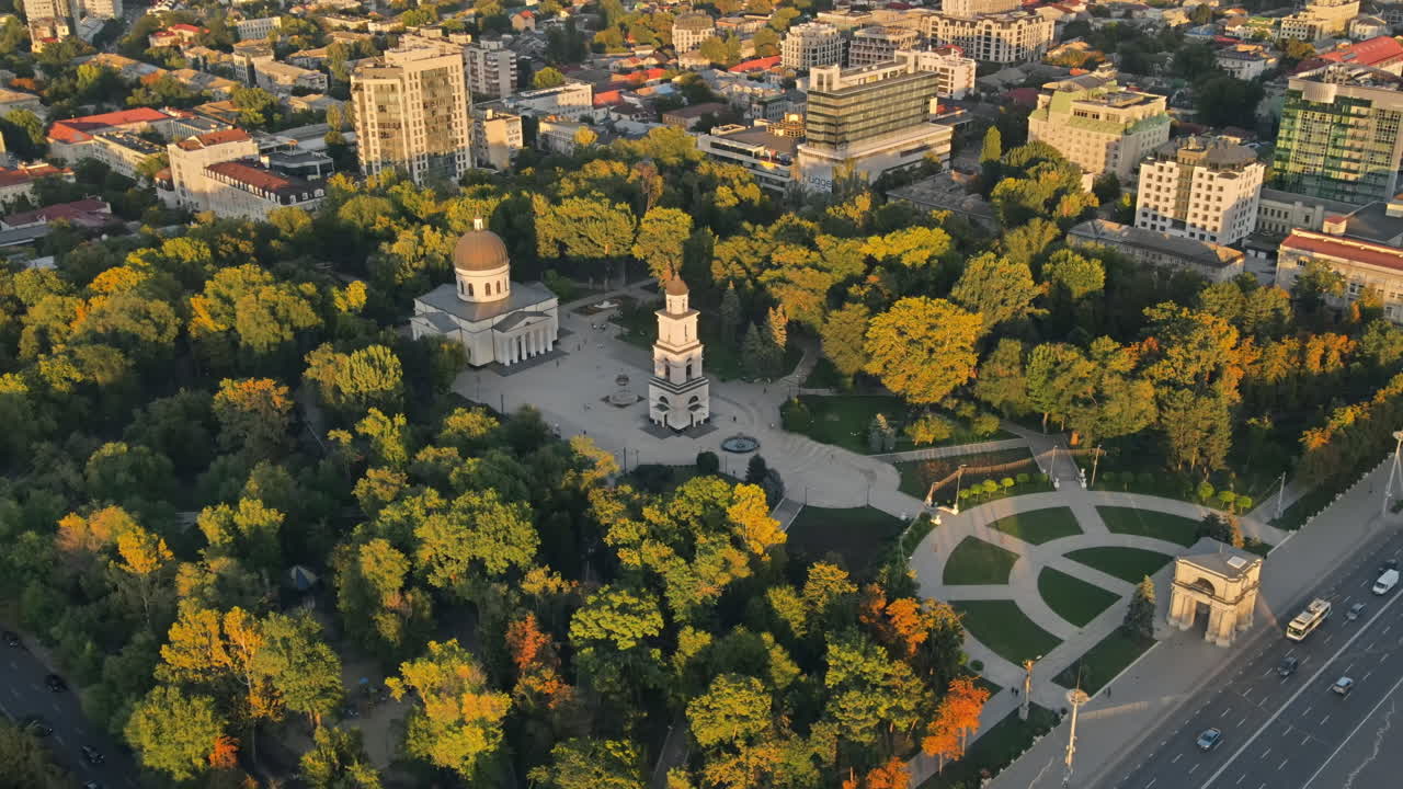 Aerial drone view of Chisinau downtown. Panorama view of central park, Cathedral, bell tower, a lot of greenery, walking people, buildings. Moldova