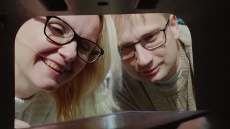 couple collect mail from mail box pov