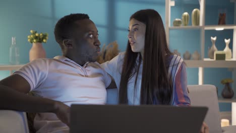 shocked, surprised happy young couple looking at laptop screen.