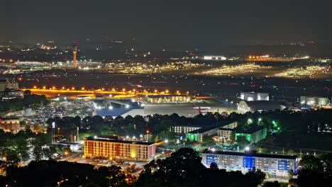 Atlanta-Georgia-Aerial-v893-hyperlapse-zoomed,-flyover-Hapeville-and-College-Park-capturing-bustling-activity-at-ATL-Hartsfield-Jackson-Airport-ground-at-night---Shot-with-Mavic-3-Pro-Cine---June-2023