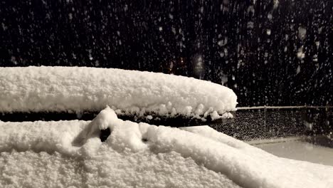 snow falling on parked car covered in snow at night blizzard - nordic weather