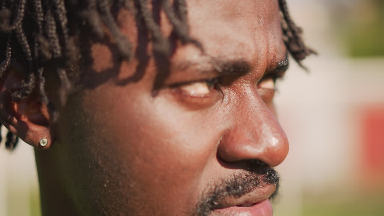 Man Concentrates Deeply During Warmweather Training Session Intense Resolve, Closeup Of Determined Athlete Practicing Under Bright Sunlight Showing Fierce Concentration And Commitment