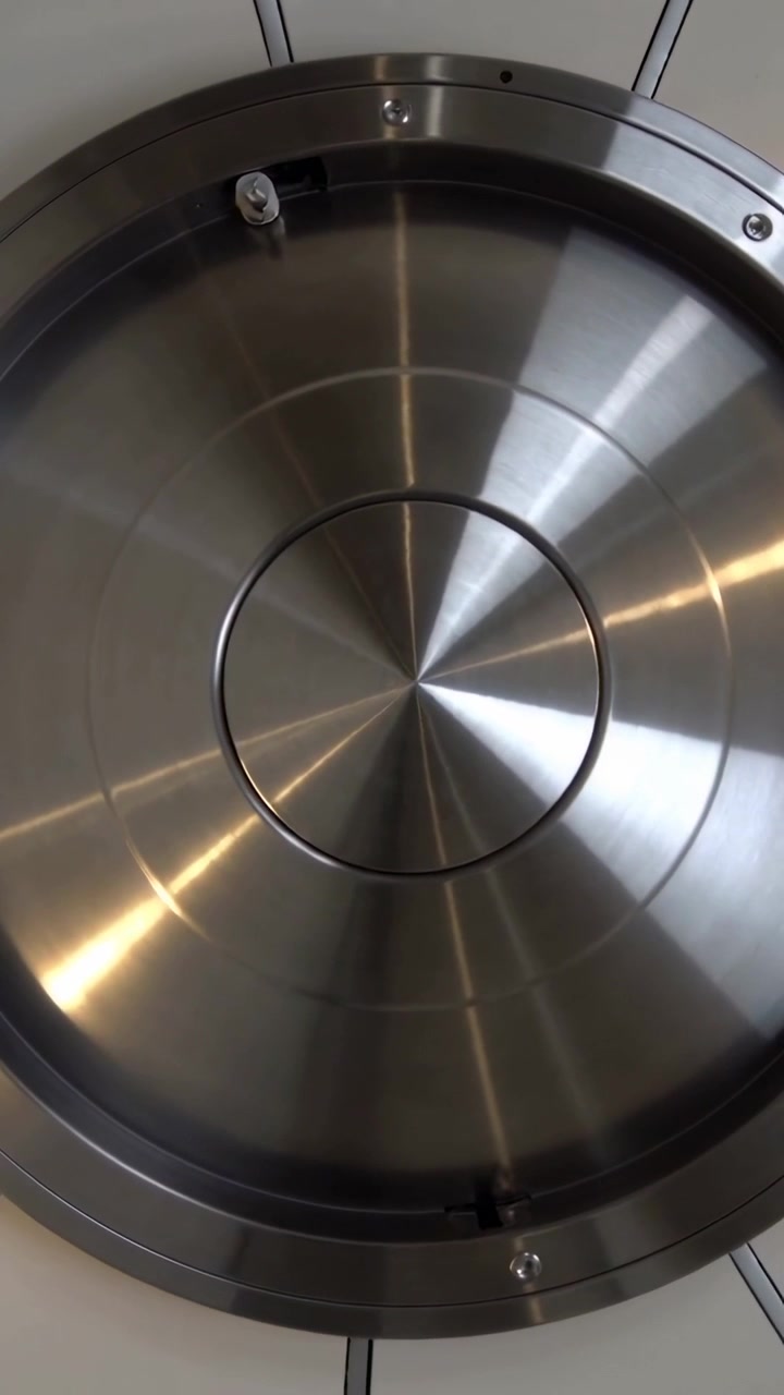 Vertical video: Tilting camera showing steel ceiling hatch shifting light to show screws and clip