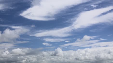Cloud-formations-moving-in-different-directions-on-bright-sunny-summer-day