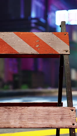 a construction barrier on a city street at night