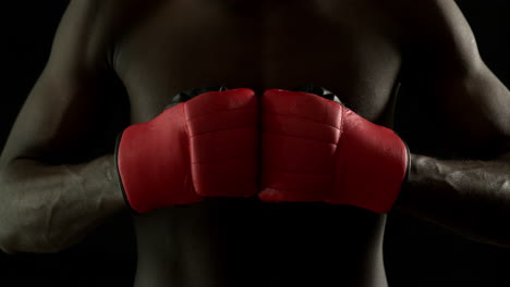 tough boxer punching fists together with red gloves