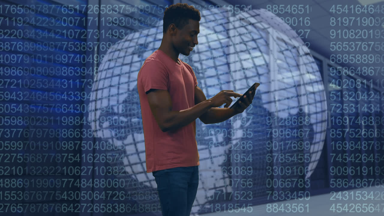 Animation of african american man using laptop over globe, computer servers and data processing