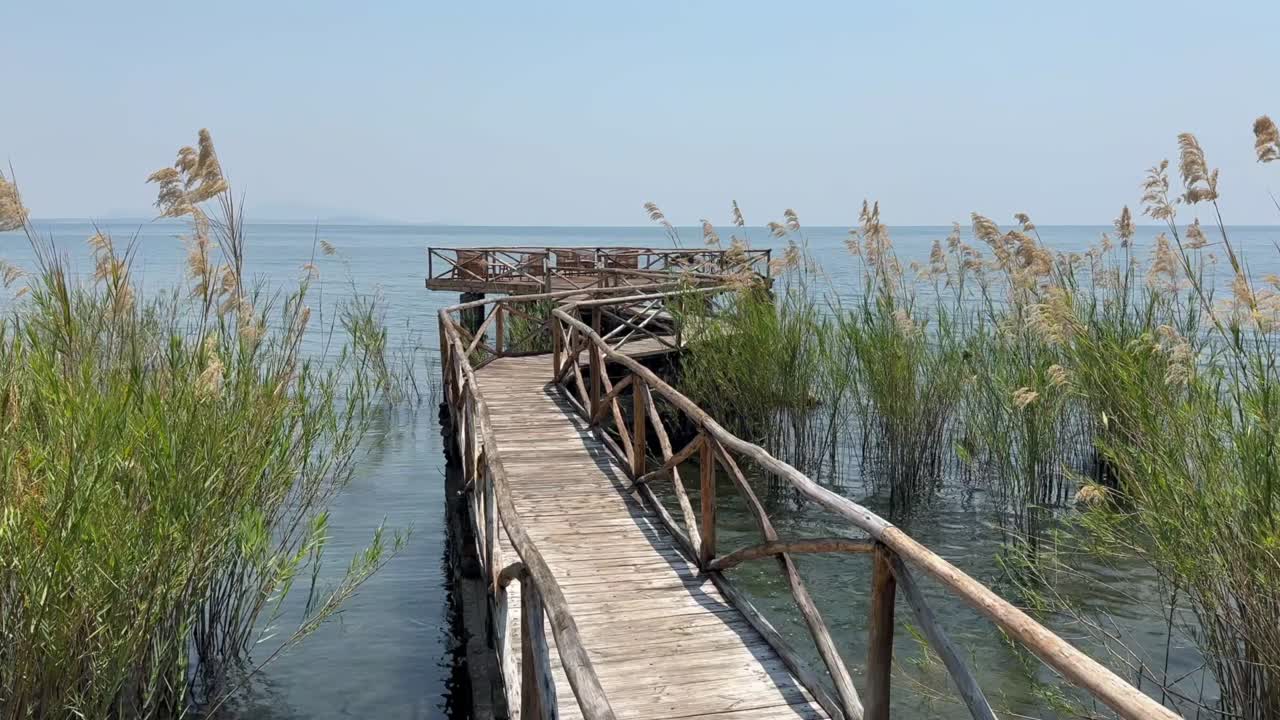 Pan left view of wooden pier on Nankoma Island. Lake Malawi, Malawi.