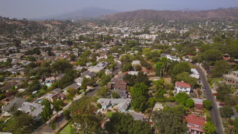 Aerial-boom-down-towards-Eagle-Rock-neighoborhood-houses-and-streets-below