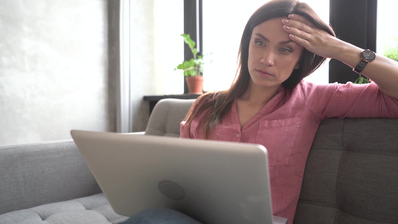 Stressed Woman Working on Laptop at Home