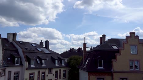 urban skyline with dynamic clouds moving over european-style buildings, daylight, timelapse