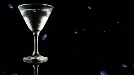 Animation-of-balls-with-australian-flag-falling-over-glass-of-martini-on-black-background