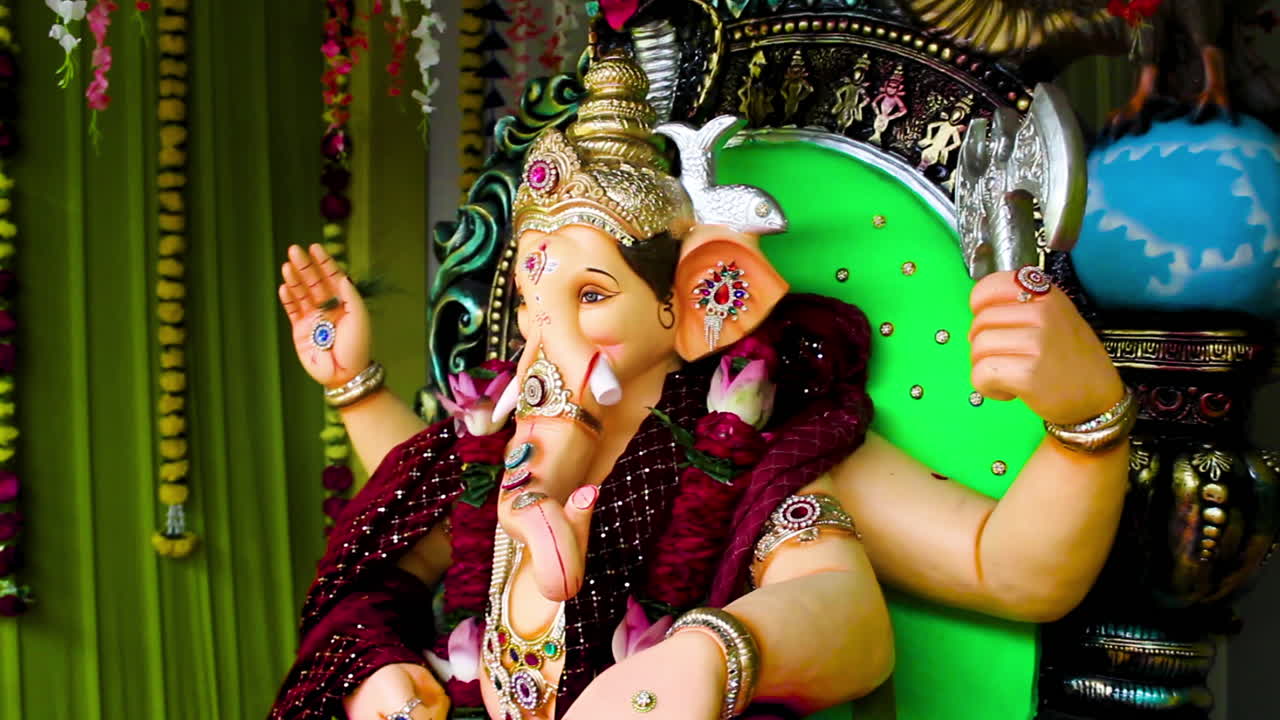Beautiful Ganesh Chaturthi idol with festive decoration, flowers and blessings. Perfect footage for festival, spirituality, culture and celebration themes