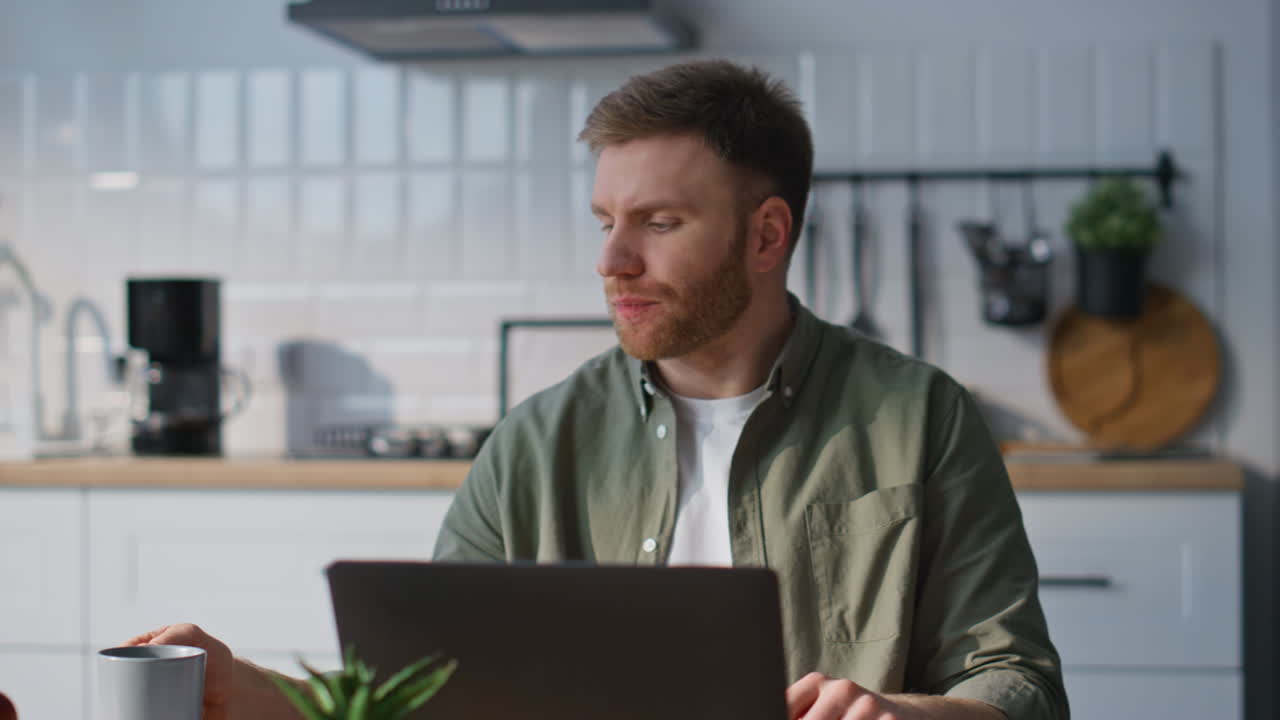 Online worker drinking coffee at remote workplace closeup. Businessman working