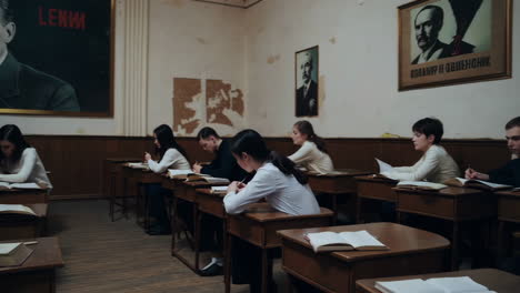 students in a classroom with a lenin poster