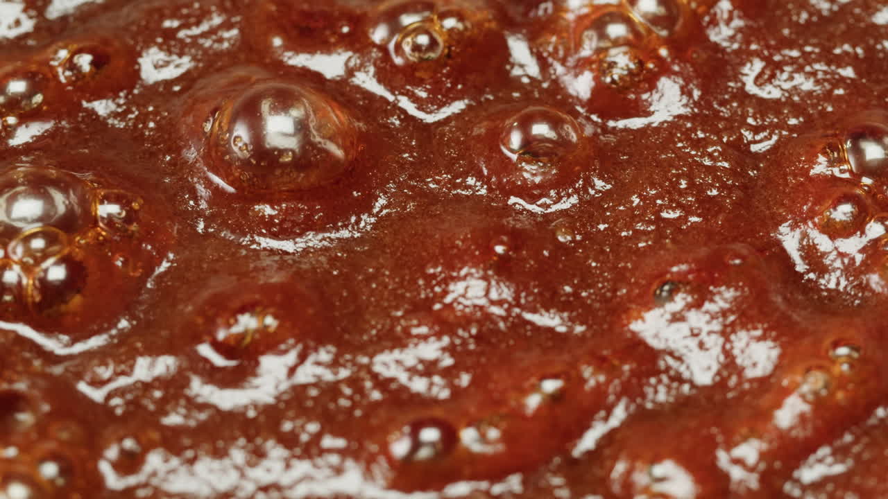Close-up of Boiling Brown Sweet Liquid with Bubbles
