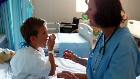 female doctor helping patient use inhaler