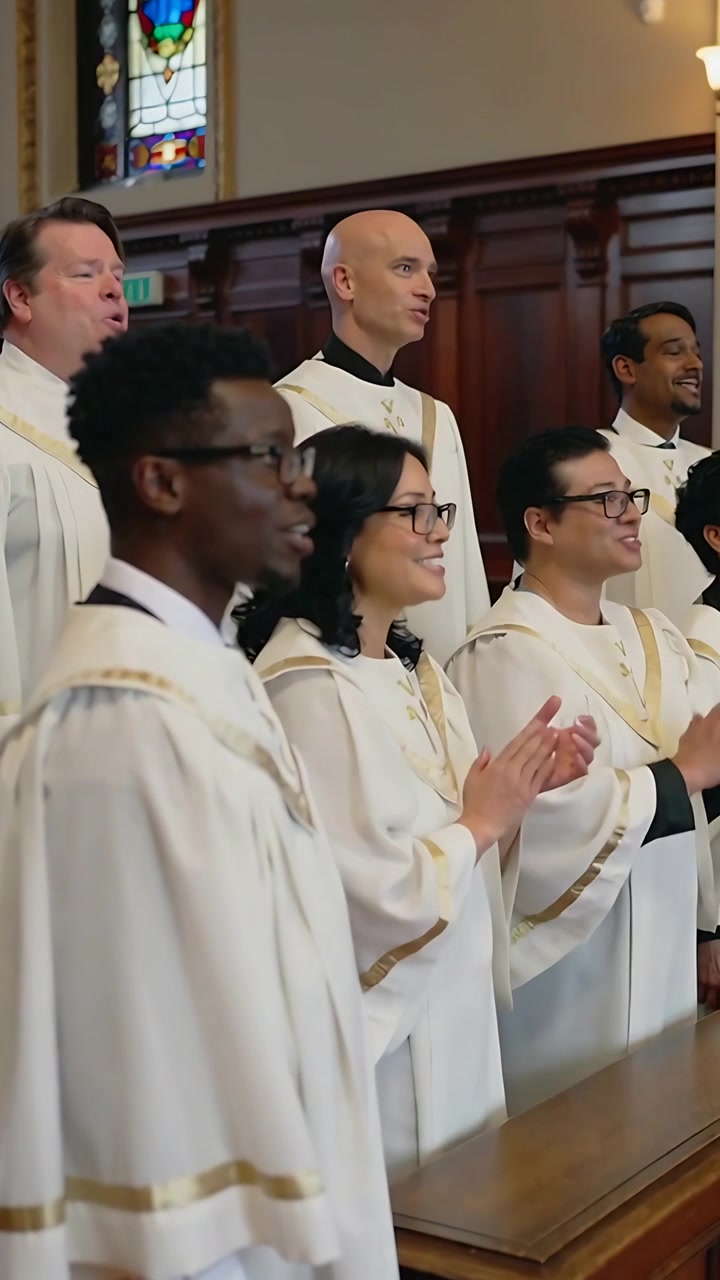 Vertical video: Clapping choir on conductor cue, singing in sanctuary by wooden rail in white robes
