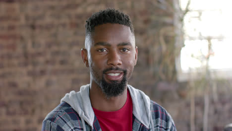 Portrait-of-happy-african-american-casual-businessman-with-short-hair-in-office-in-slow-motion