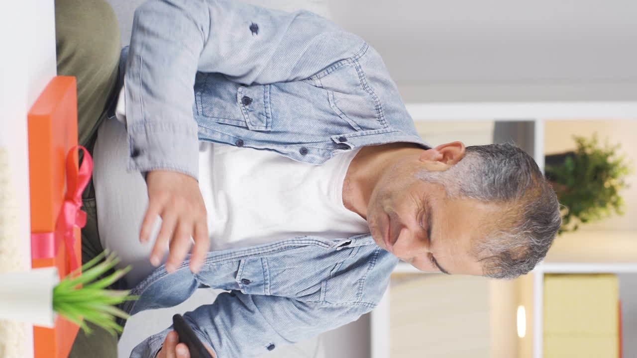 Vertical video of Lonely man thinks of his family.