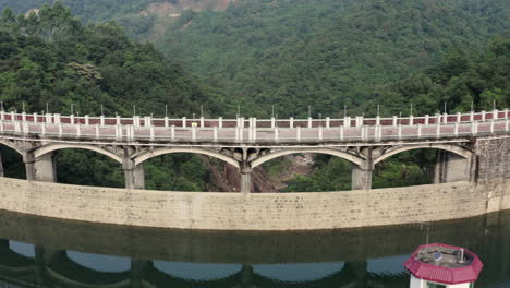 fly over a water dam on a small mountain river