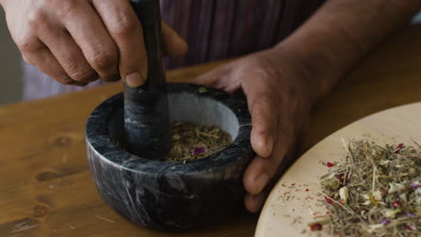 preparing herbs and spices with mortar and pestle