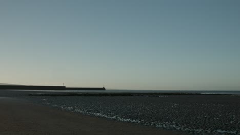 shot of swansea bay including 2 piers with a stunning sunrise 4k