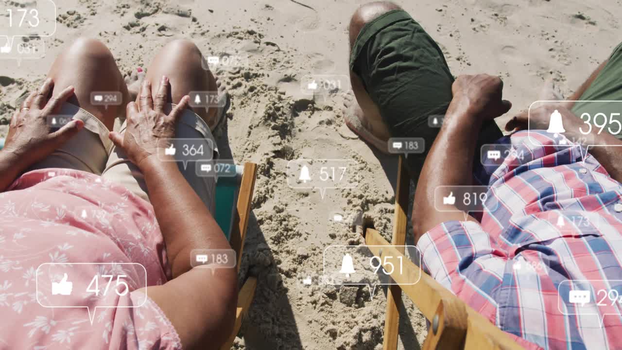 Senior couple on beach seeing floating social icons, tapping then choosing connection over feed