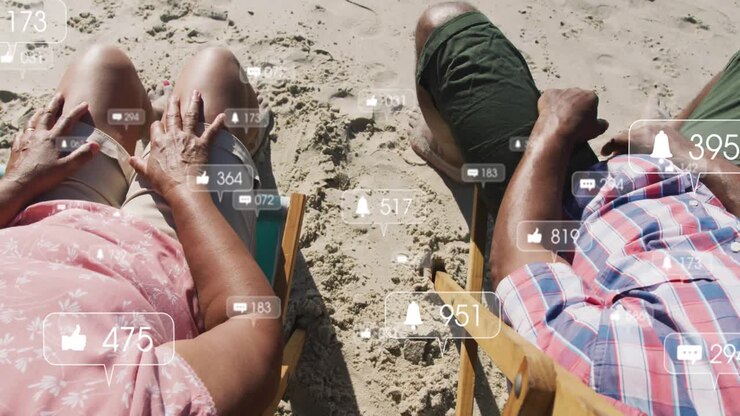 Senior couple on beach seeing floating social icons, tapping then choosing connection over feed
