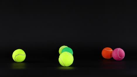 vibrant tennis balls bouncing against a dark background