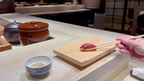 chopsticks picking sushi at a restaurant