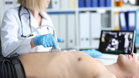 doctor performing ultrasound examination on a patient's abdomen