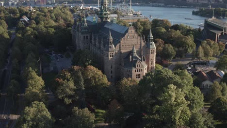 aerial view of nordiska museet with gröna lund in background on sunny evening on djurgården in stockholm, sweden