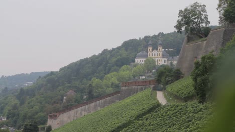 view of bamberg church on a hillside with lush greenery and a pathway winding through vineyards