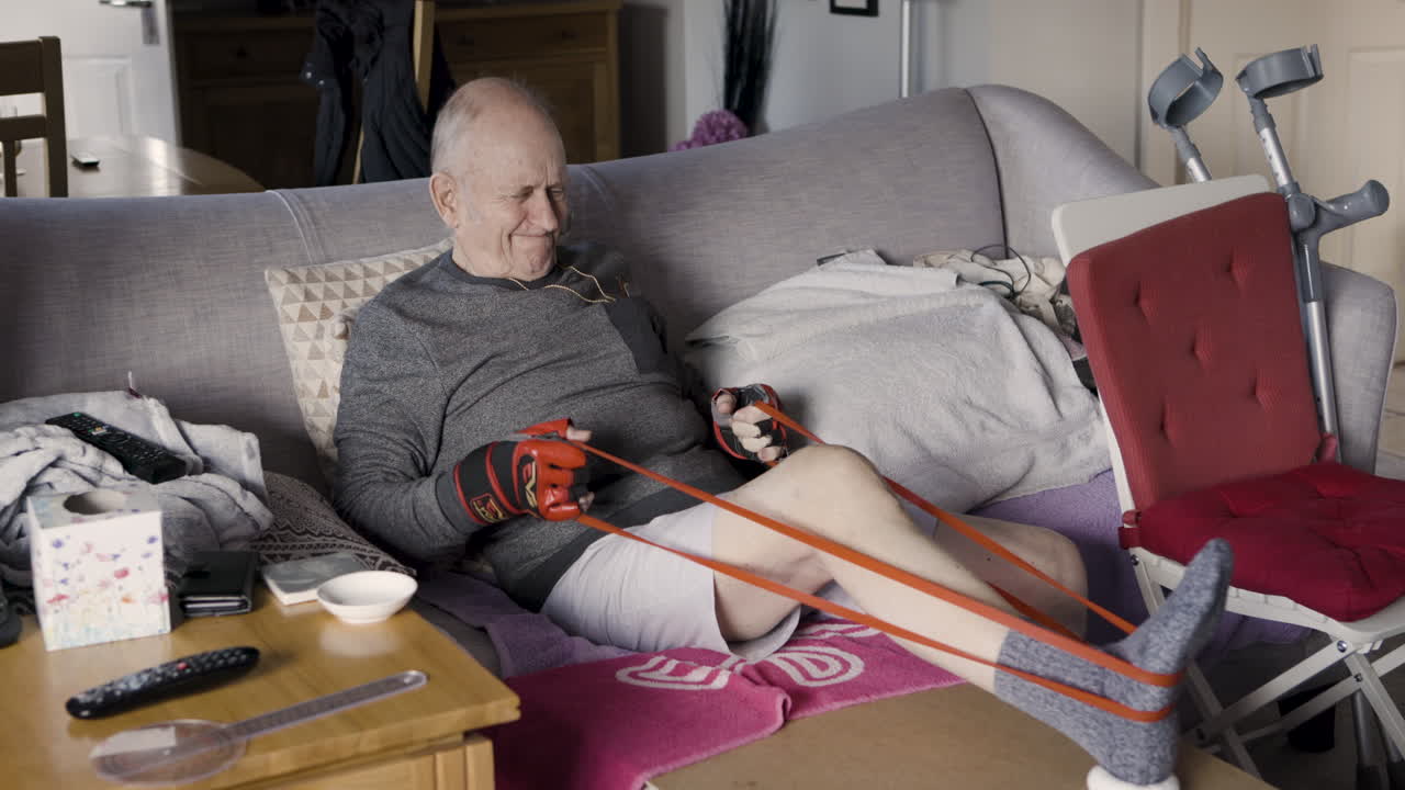 Elderly man exercising with resistance band at home