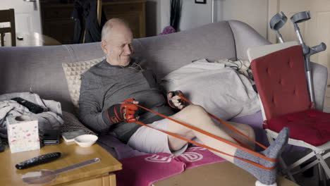 elderly man exercising with resistance band at home