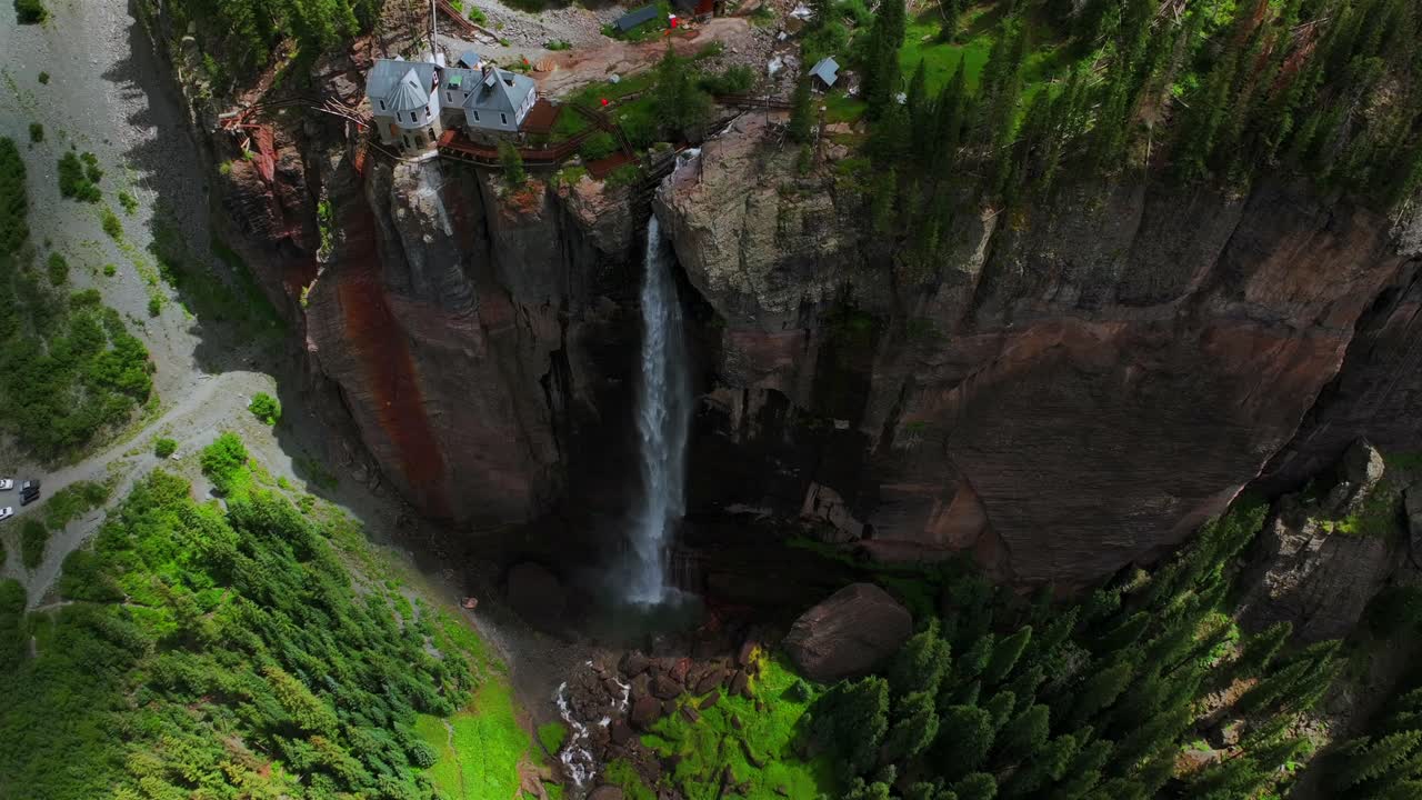 Summer green Telluride Bridal Veil Falls Waterfall Colorado powerplant house aerial drone Box Canyon Black Bear Pass Road Rocky Mountains 4wd hiking blue sky cliffside Uncompahgre Forest downward pan
