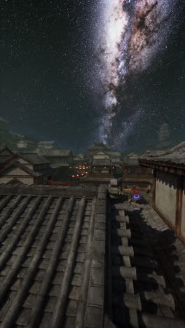 vista nocturna de una aldea japonesa con la vía láctea en el cielo
