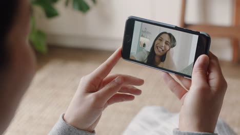 Mujer-Joven-Teniendo-Video-Chat-Usando-Un-Teléfono-Inteligente-En-Casa-Charlando-Con-Un-Amigo-Disfrutando-De-Una-Conversación-Compartiendo-Su-Estilo-De-Vida-En-Un-Teléfono-Móvil