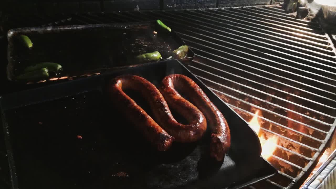 Sauage cooking on a grill