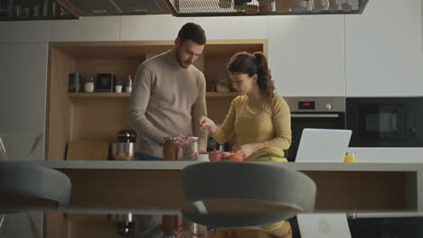 couple preparing breakfast together in a modern kitchen
