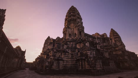 sunrise rays glowing up angkor wat central towers early one morning with nobody in view during covid-19