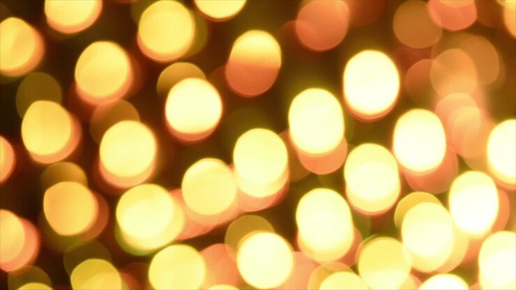 Luci bokeh dorate e calde che appaiono e scompaiono