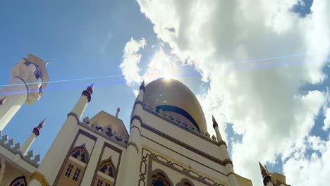 facade of sultan mosque against bright sunny sky in kampong glam, singapore with sun flare effects