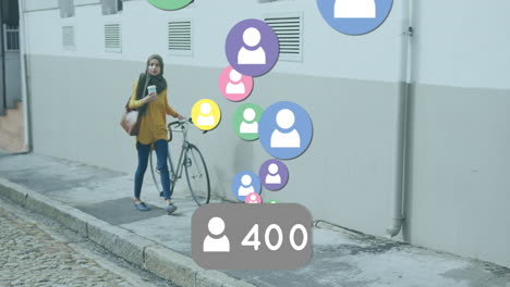 animation of colourful people icons with woman in hijab wheeling bicycle in street