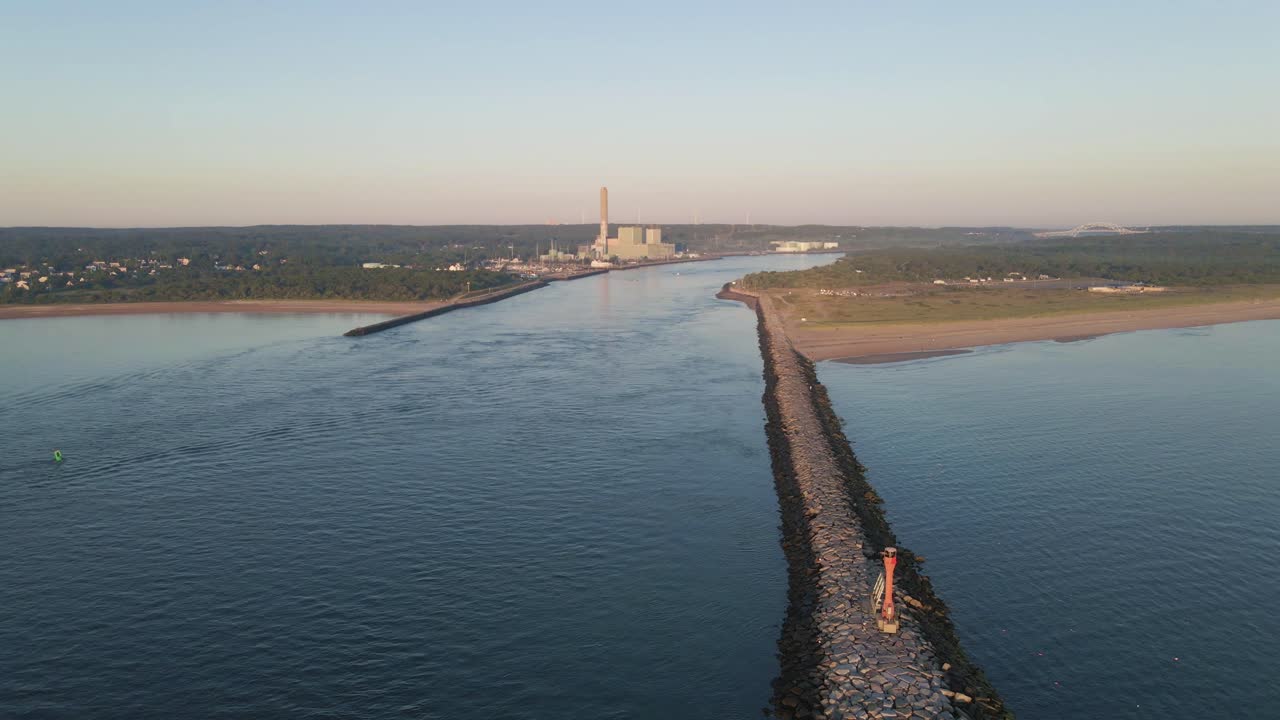 aerial view of ocean pier alongside canal with factory and bridge