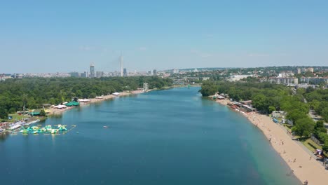 Aerial-shot-dollying-back-along-a-river-in-Belgrade-capital-of-Serbia-on-a-bright-day