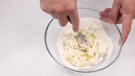 making the dough for baking. mix the flour and mashed eggs in a glass bowl